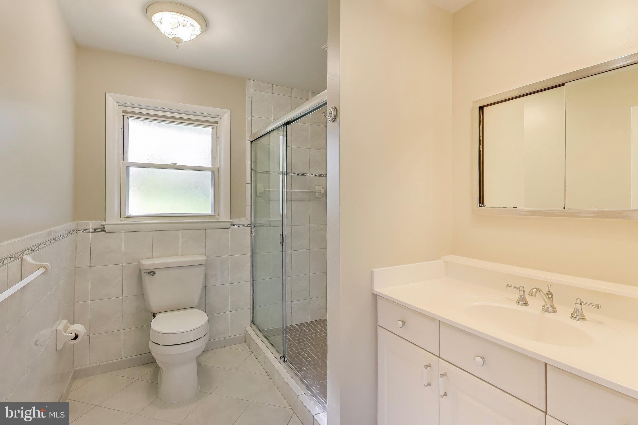 402 Ivy Church Road Lutherville-Timonium, MD 21093 - Photo 40 of 63 a bathroom with a toilet sink vanity and mirror