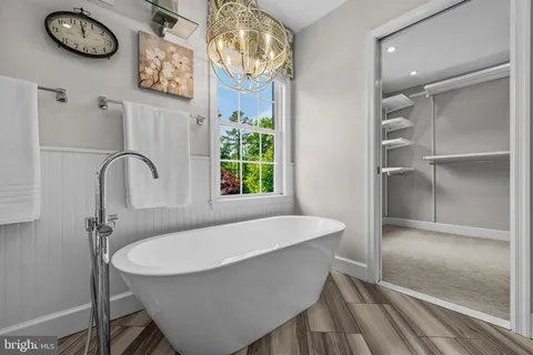 a spacious bathroom with a granite countertop sink mirror and shower