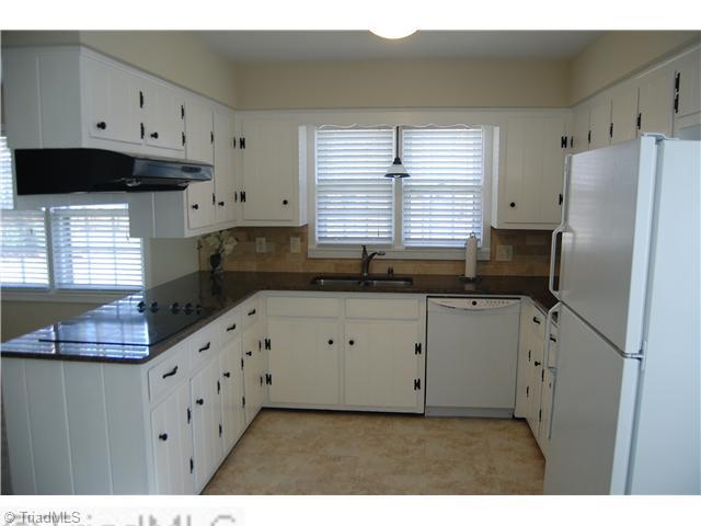 691 Chester Road Winston-Salem, NC 27104 - Photo 3 of 16 Kitchen. Kitchen with granite countertops, new sink, new cooktop, new dishwasher, and builtin oven.