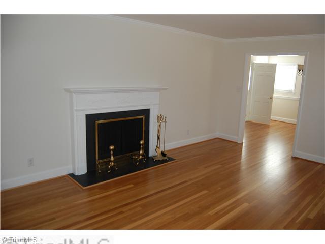 691 Chester Road Winston-Salem, NC 27104 - Photo 5 of 16 Living Room. Living room with fireplace and refinished hardwood flooring.