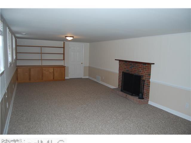 691 Chester Road Winston-Salem, NC 27104 - Photo 7 of 16 Playroom. Playroom in basement with fireplace and builtin shelves.