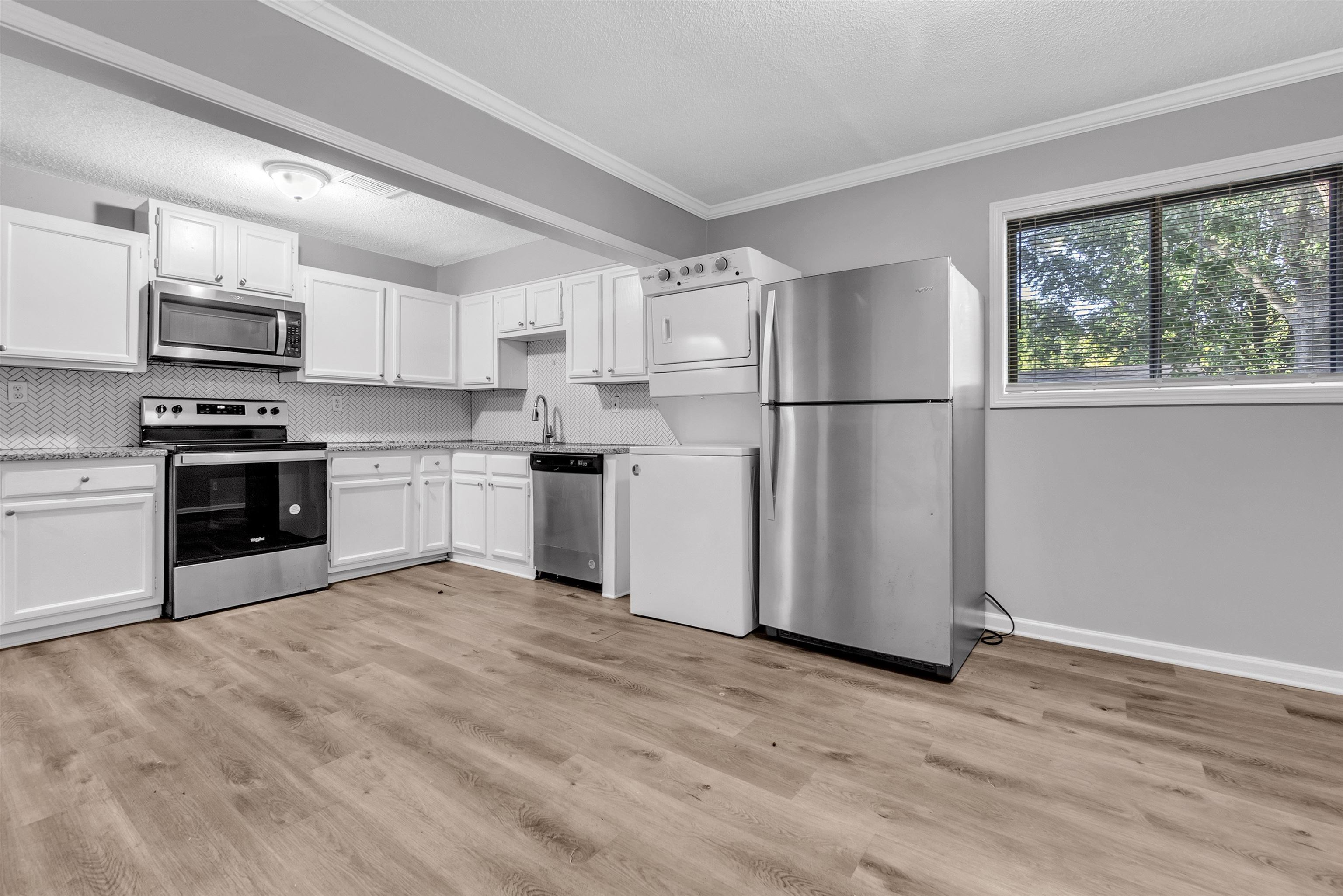 1136 South White Station Road Memphis, TN 38117 - Photo 13 of 19 a kitchen with kitchen island a refrigerator and a stove top oven