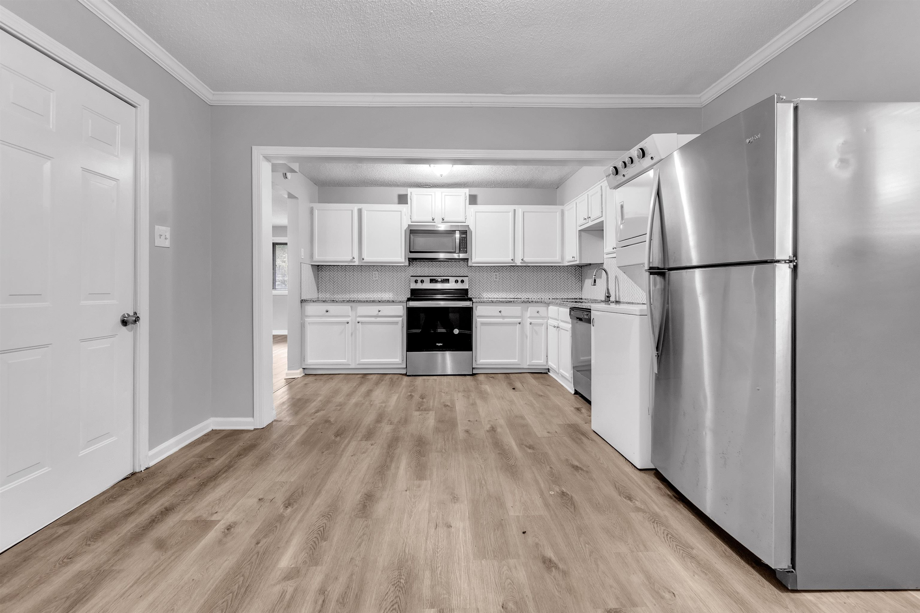 1136 South White Station Road Memphis, TN 38117 - Photo 14 of 19 a kitchen with kitchen island wooden floors appliances and cabinets
