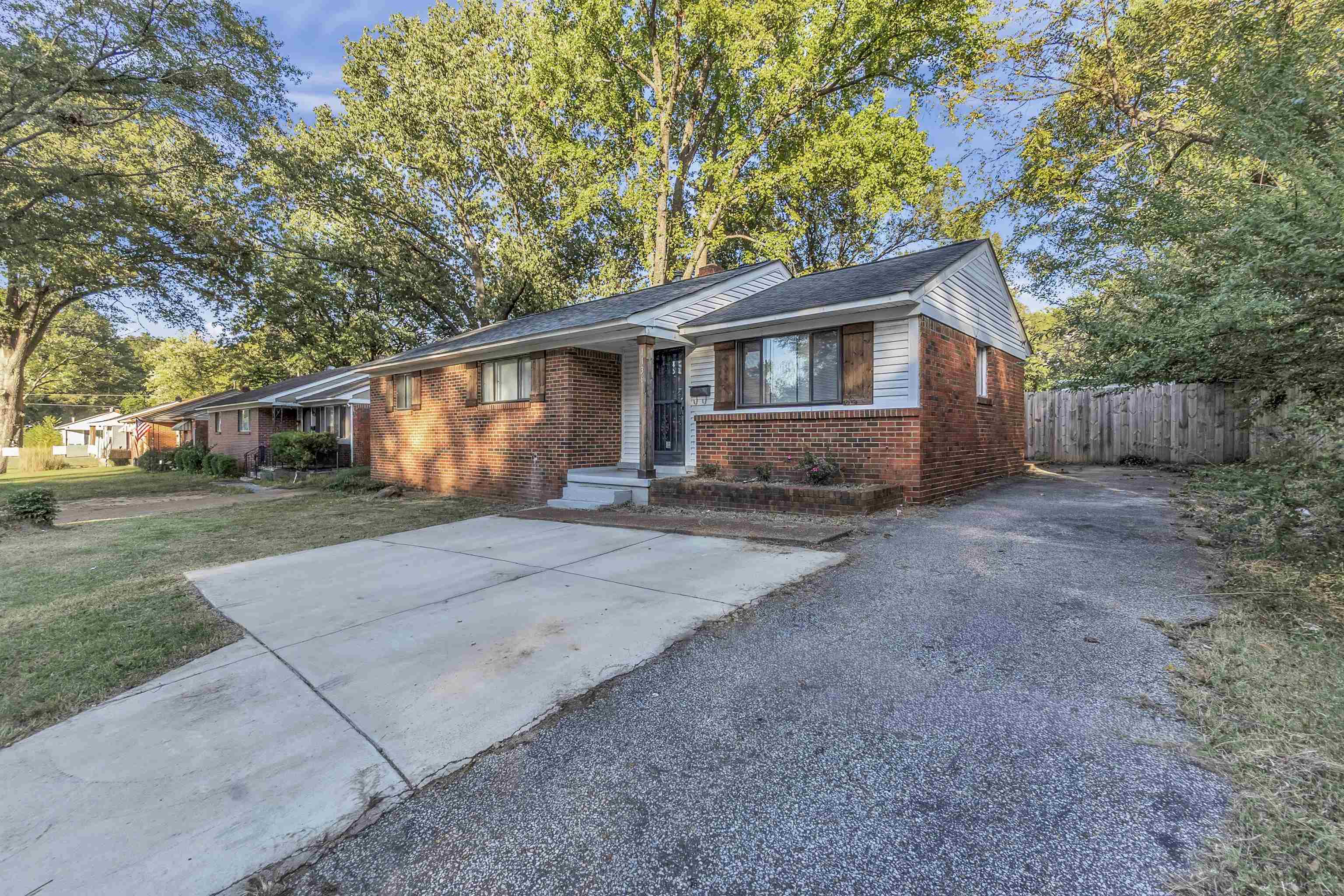 1136 South White Station Road Memphis, TN 38117 - Photo 2 of 19 a front view of a house with a yard and garage