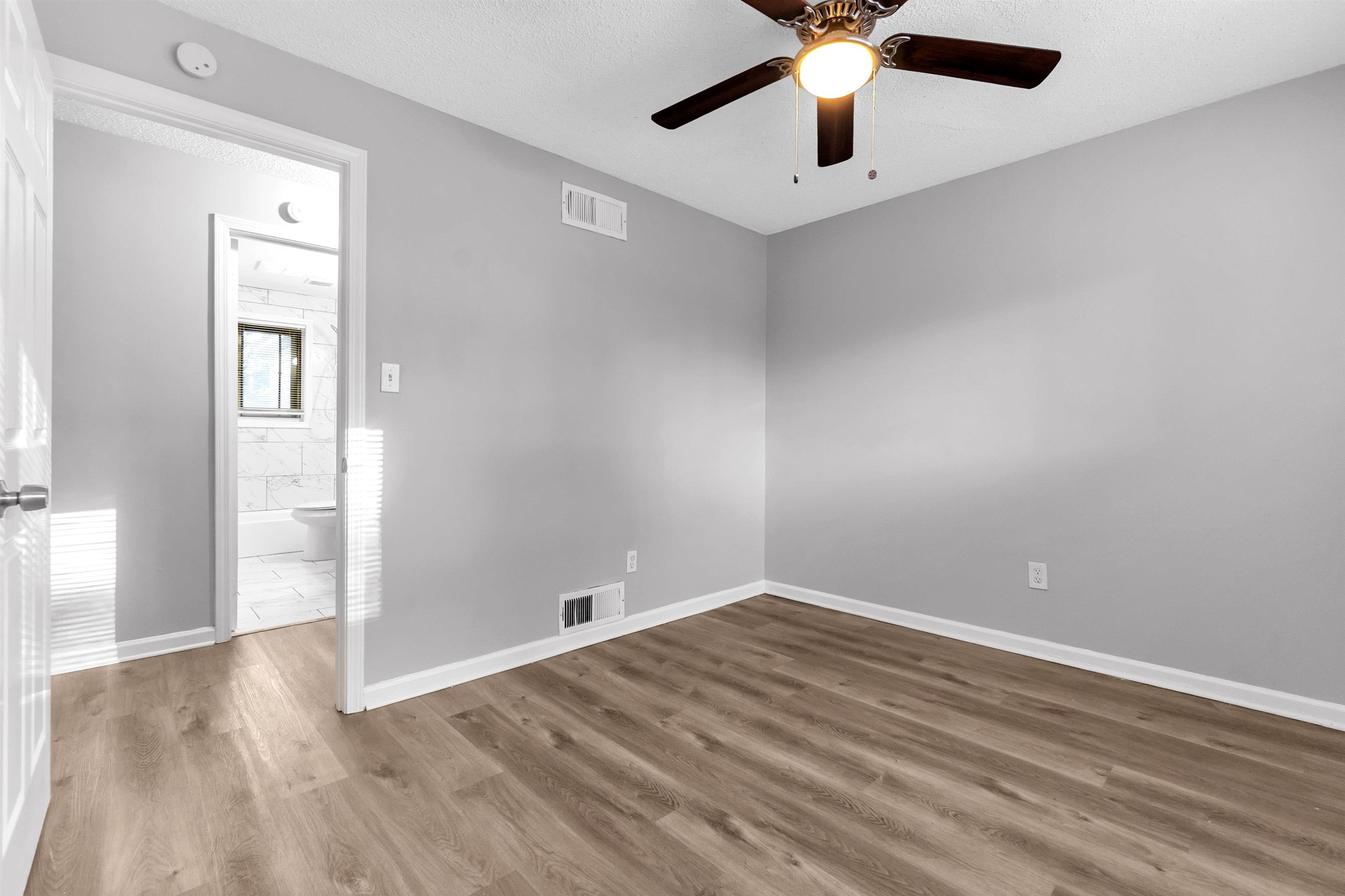 1136 South White Station Road Memphis, TN 38117 - Photo 3 of 19 wooden floor in an empty room with a window
