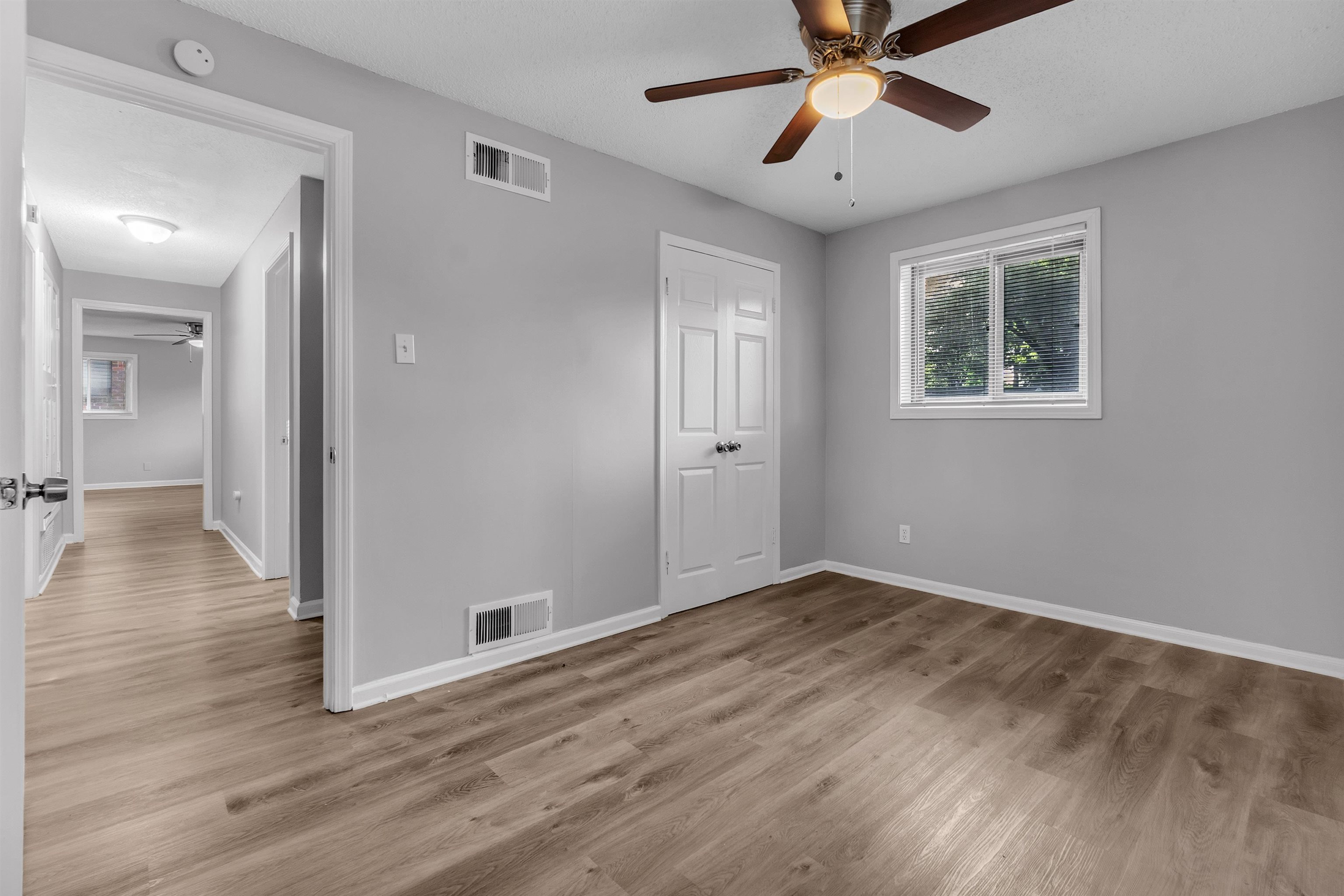 1136 South White Station Road Memphis, TN 38117 - Photo 5 of 19 a view of an empty room with window and wooden floor