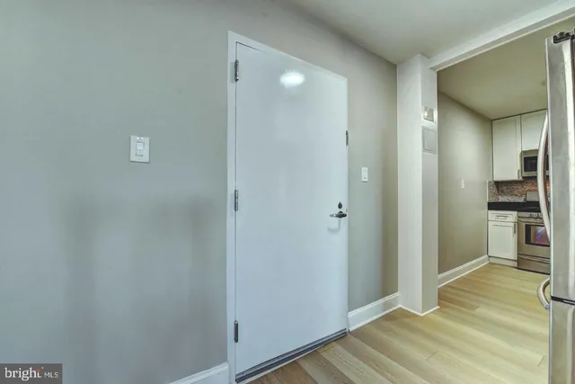 a view of a room with wooden floor