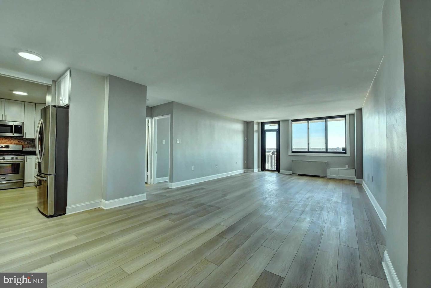 801 North Pitt Street, Unit 1206 Alexandria, VA 22314 - Photo 12 of 37 a view of an empty room with window and wooden floor
