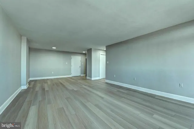 a view of an empty room and wooden floor