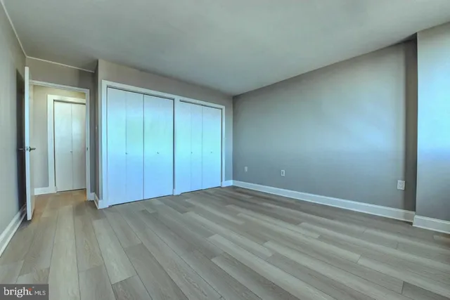 a view of an empty room and wooden floor