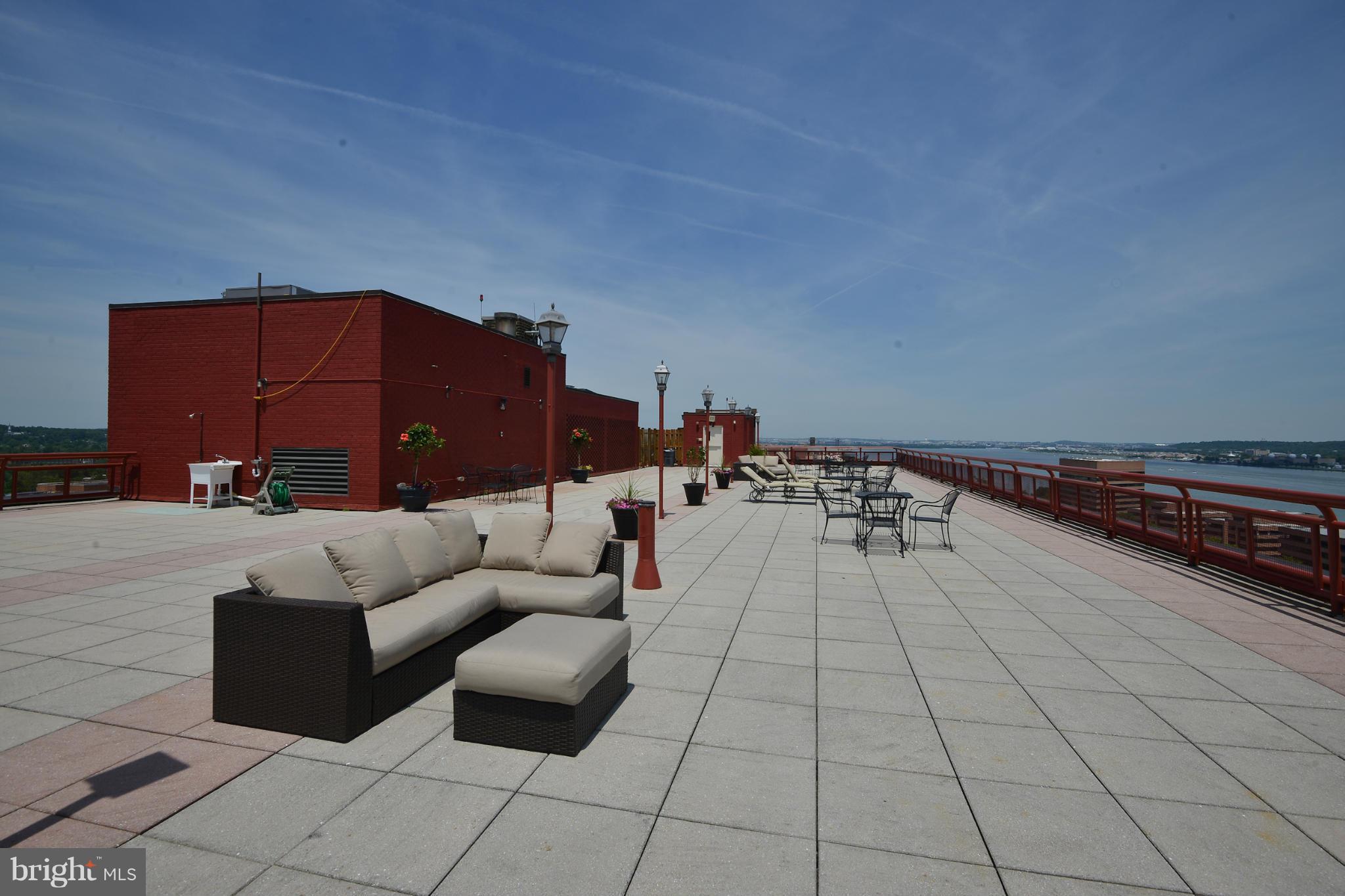 801 North Pitt Street, Unit 1206 Alexandria, VA 22314 - Photo 28 of 37 a balcony with furniture and a rug