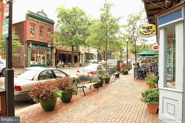 a balcony with wooden benches and city view