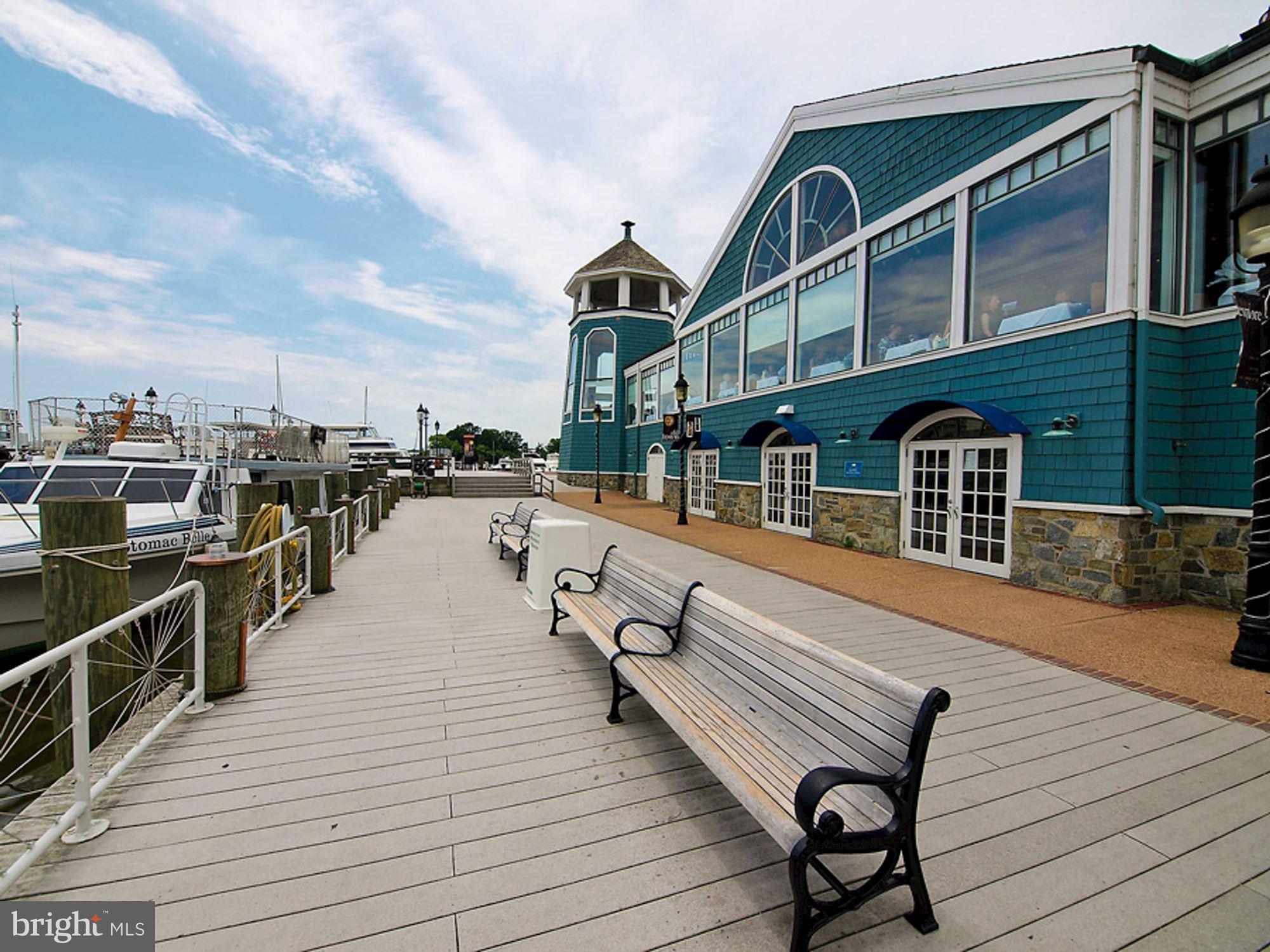 801 North Pitt Street, Unit 1206 Alexandria, VA 22314 - Photo 36 of 37 a balcony with wooden benches and city view