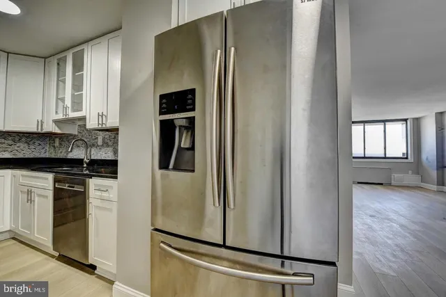 a kitchen with stainless steel appliances granite countertop a refrigerator and a stove