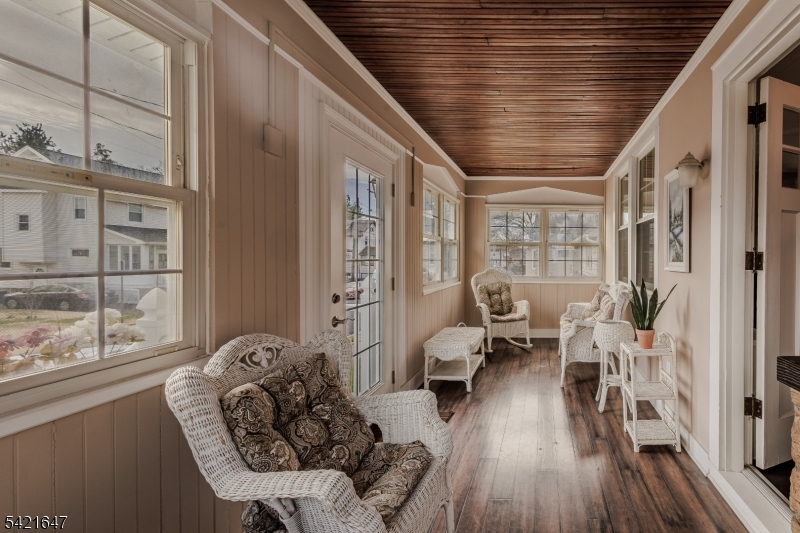 a living room with furniture or wooden floor and a large window