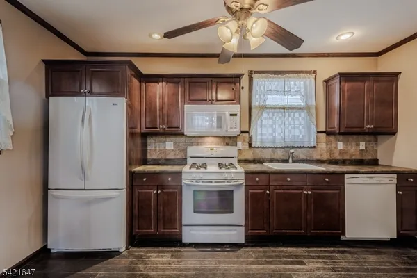 a kitchen with stainless steel appliances granite countertop a stove and a refrigerator