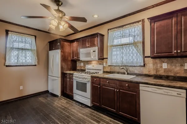 a kitchen with stainless steel appliances granite countertop a stove sink and cabinets