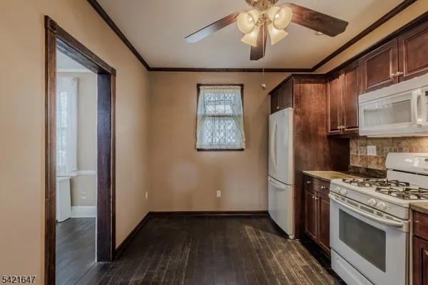a kitchen with stainless steel appliances a refrigerator and a stove top oven