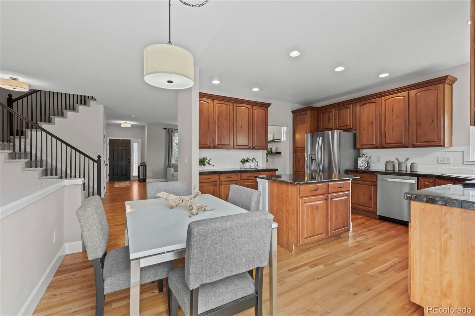 4463 Eagle River Run Broomfield, CO 80023 - Photo 17 of 44 a large kitchen with a table and chairs