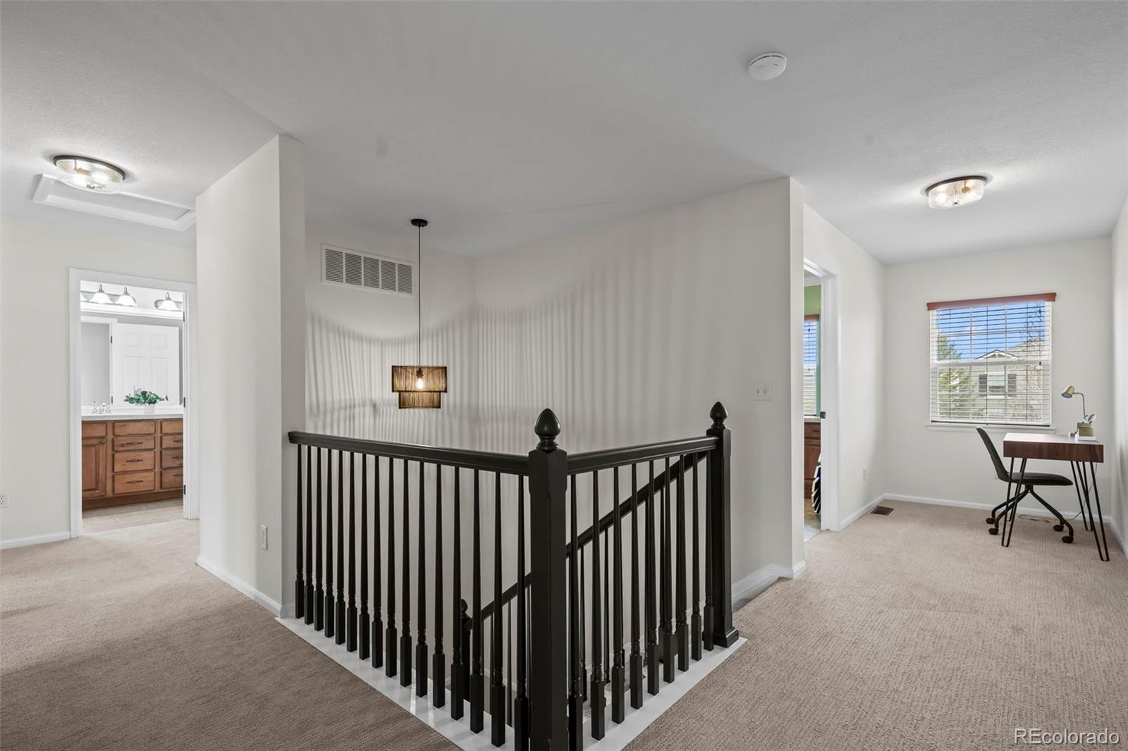 4463 Eagle River Run Broomfield, CO 80023 - Photo 21 of 44 a view of a hallway with workspace