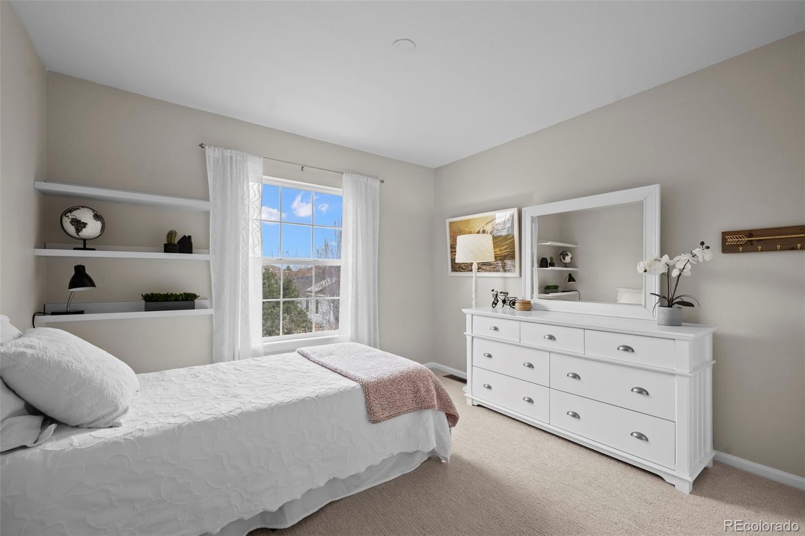 4463 Eagle River Run Broomfield, CO 80023 - Photo 26 of 44 a bedroom with a bed and a dresser