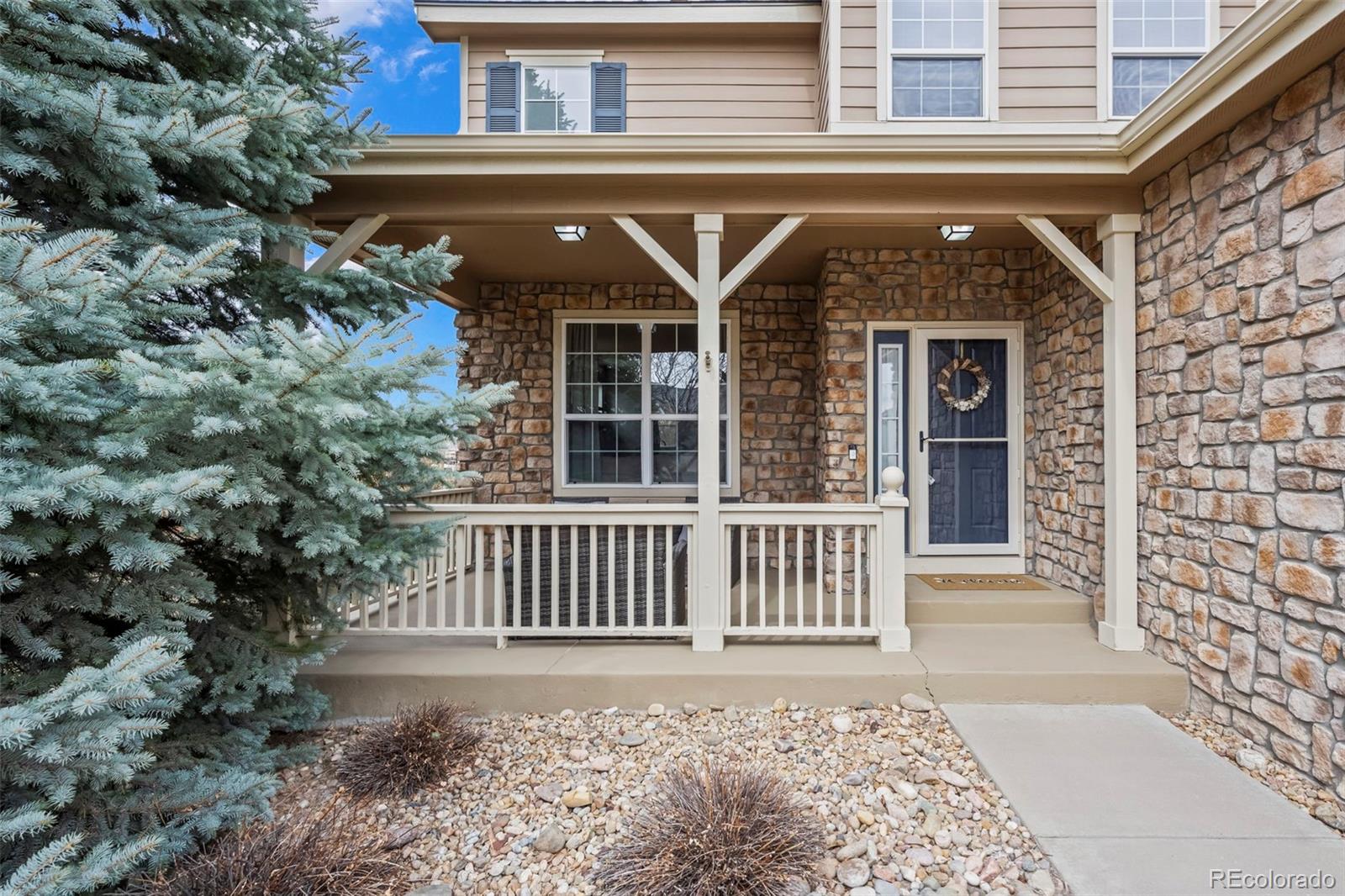 4463 Eagle River Run Broomfield, CO 80023 - Photo 3 of 44 a front view of a house with garden