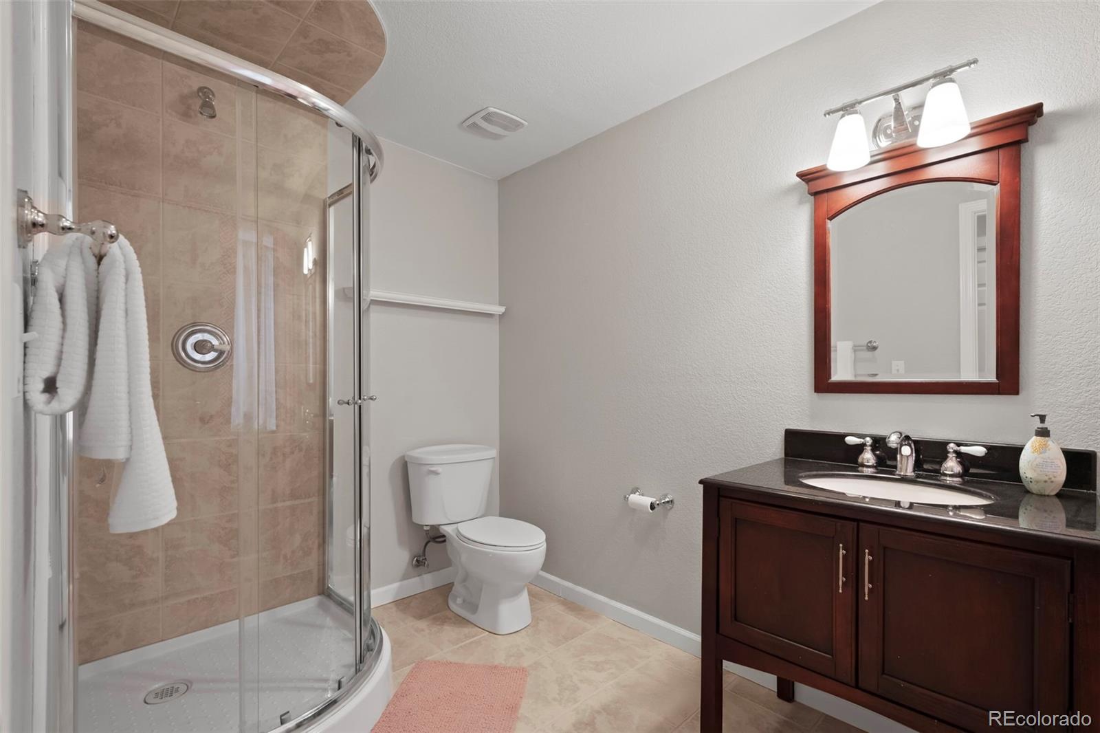 4463 Eagle River Run Broomfield, CO 80023 - Photo 33 of 44 a bathroom with a toilet sink and shower