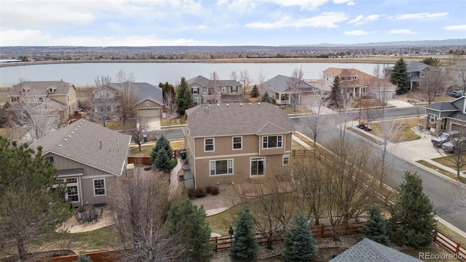 4463 Eagle River Run Broomfield, CO 80023 - Photo 40 of 44 aerial view of a house with outdoor space and a lake view in back