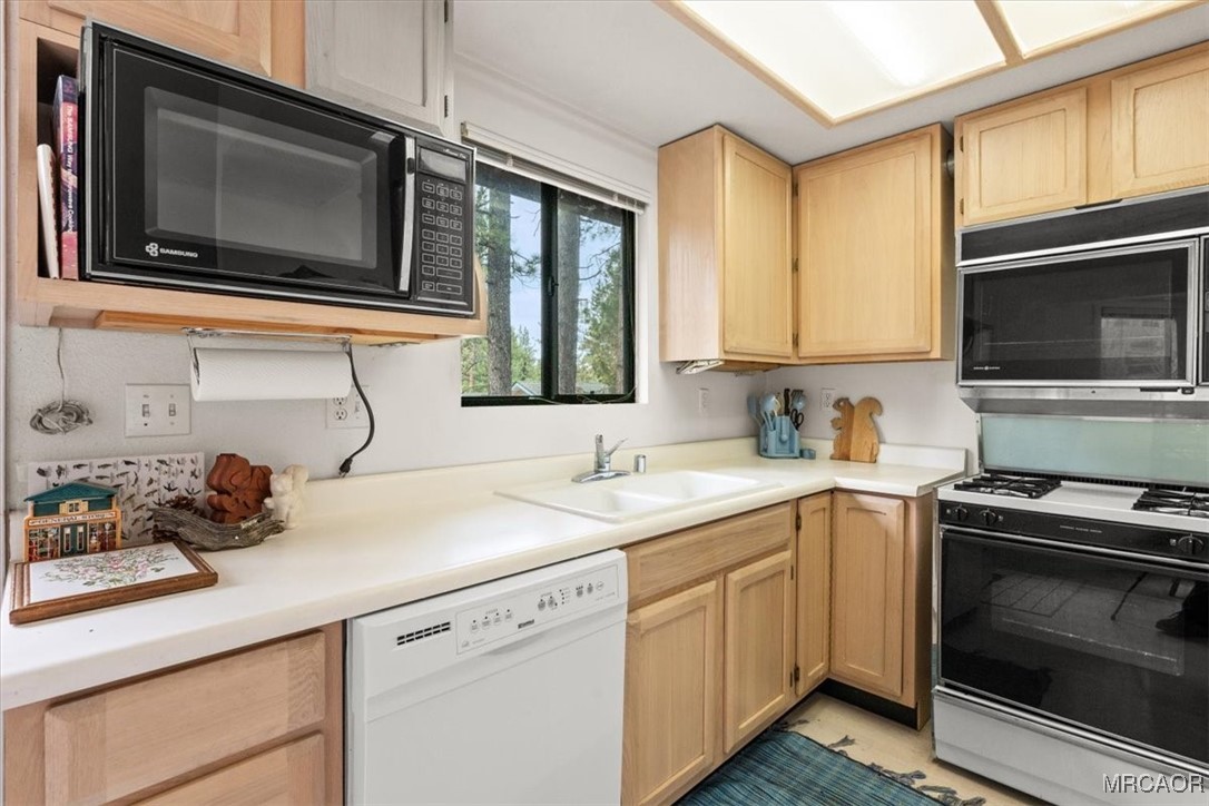 148 Crystal Lake Road Big Bear Lake, CA 92315 - Photo 11 of 29 a kitchen with a sink stove and microwave