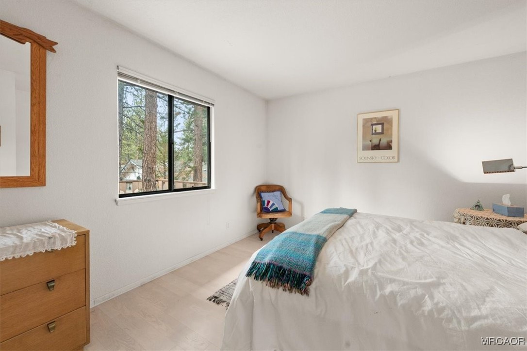 148 Crystal Lake Road Big Bear Lake, CA 92315 - Photo 16 of 29 a bed room with a bed and a window