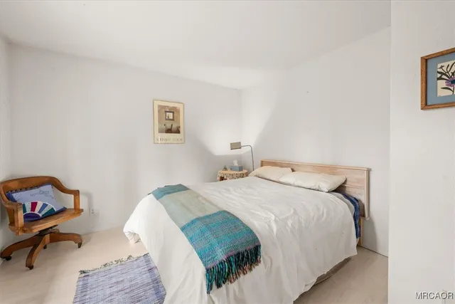 a bedroom with a bed and a desk