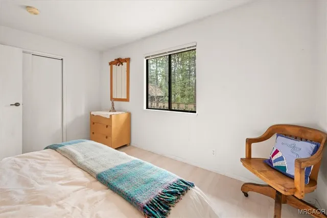 a bedroom with a bed and window