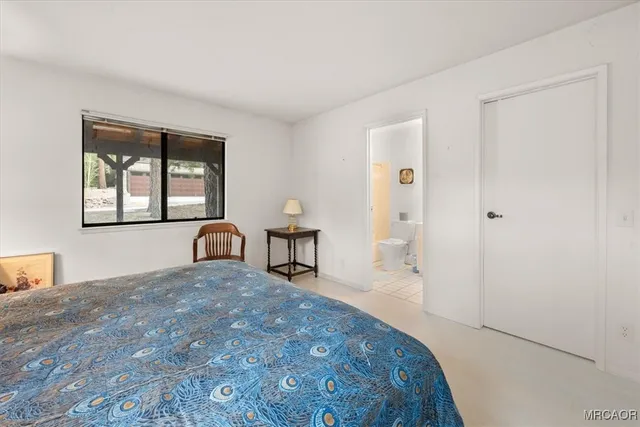 a view of a bedroom with a bed and window