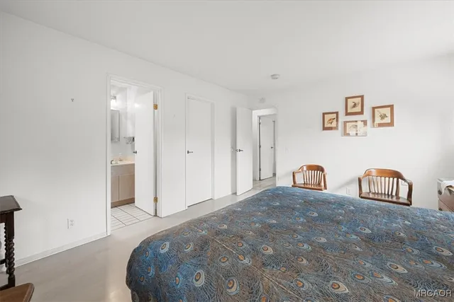 a bedroom with a bed and a table