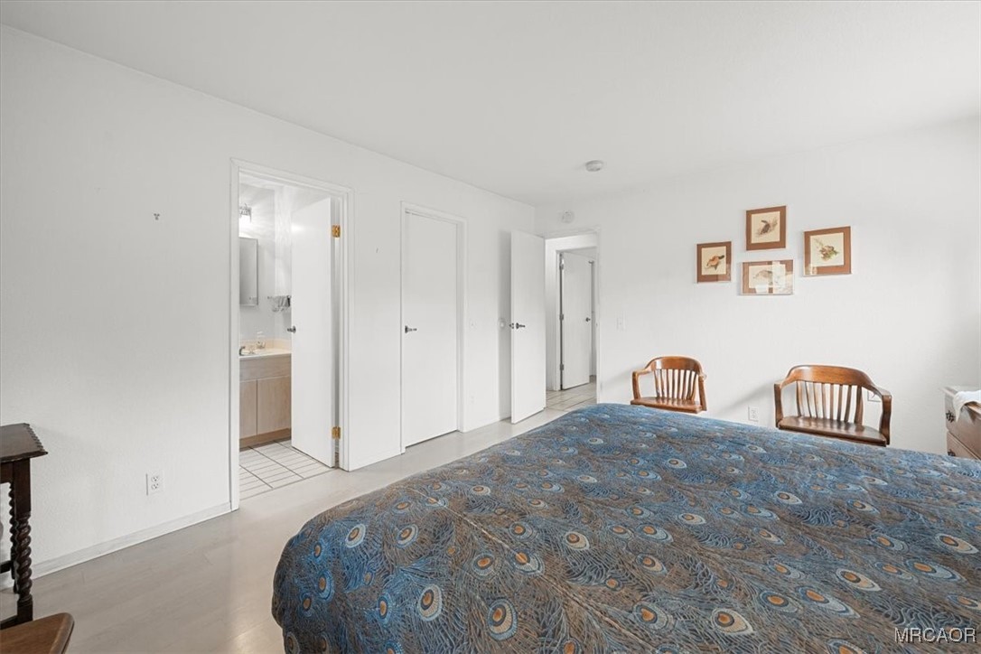 148 Crystal Lake Road Big Bear Lake, CA 92315 - Photo 22 of 29 a bedroom with a bed and a table