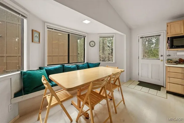 a view of a dining room with furniture and a window