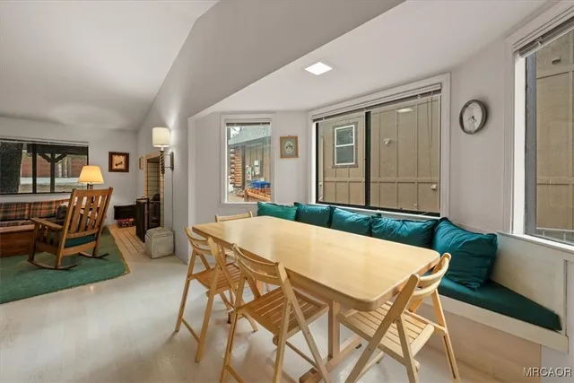 a view of a dining room with furniture and a window