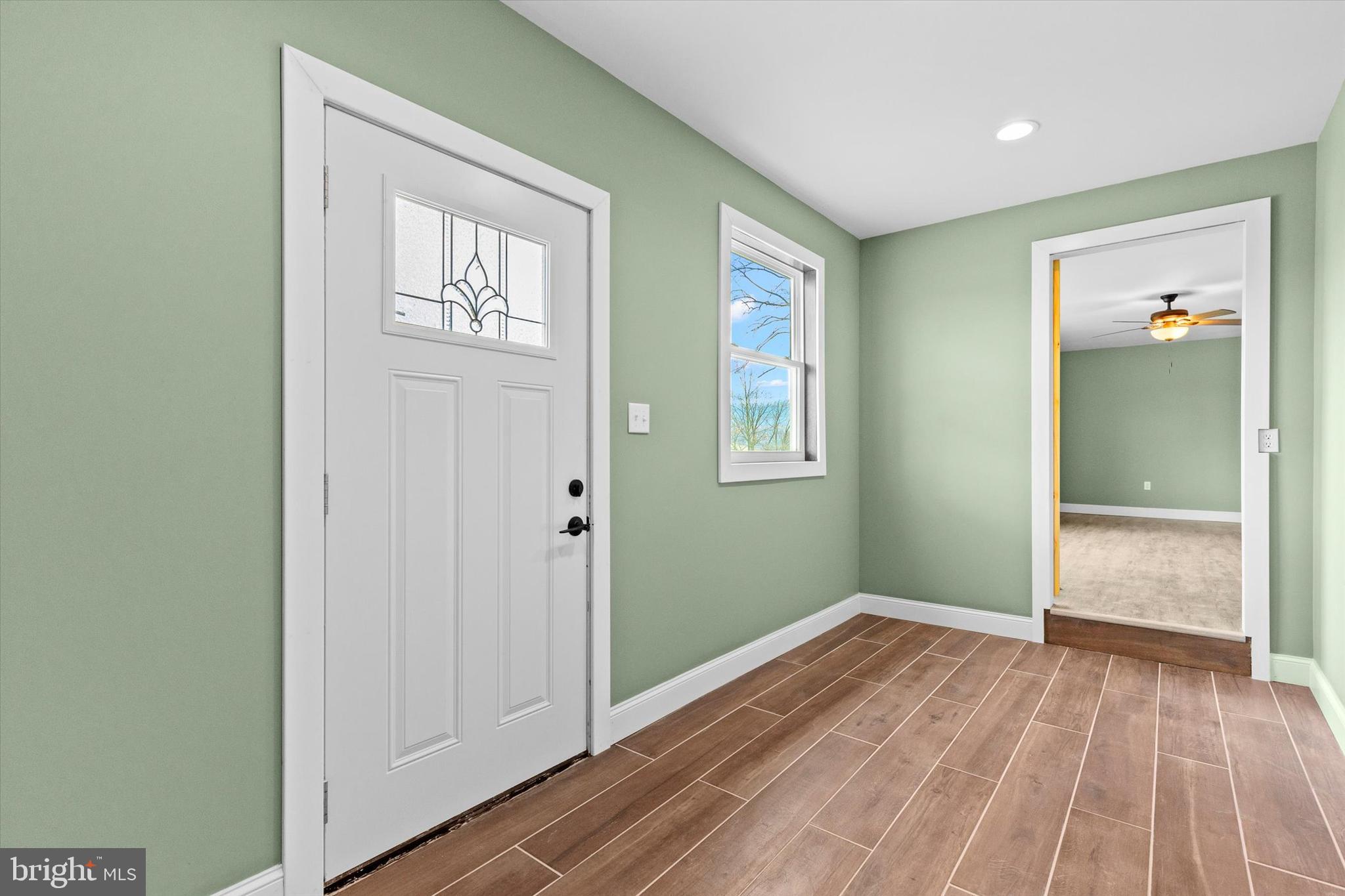 1228 Matamoras Road Halifax, PA 17032 - Photo 5 of 45 a view of an empty room with wooden floor and a window