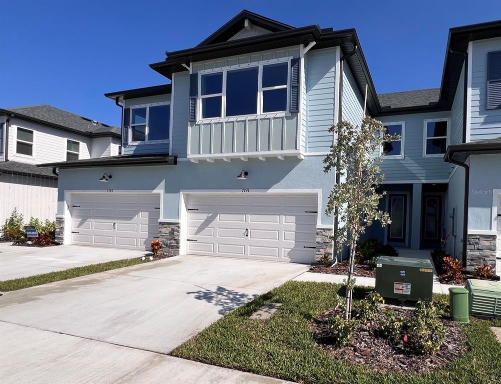 7741 93rd Street North Seminole, FL 33777 - Photo 3 of 11 a front view of a house with a yard and garage