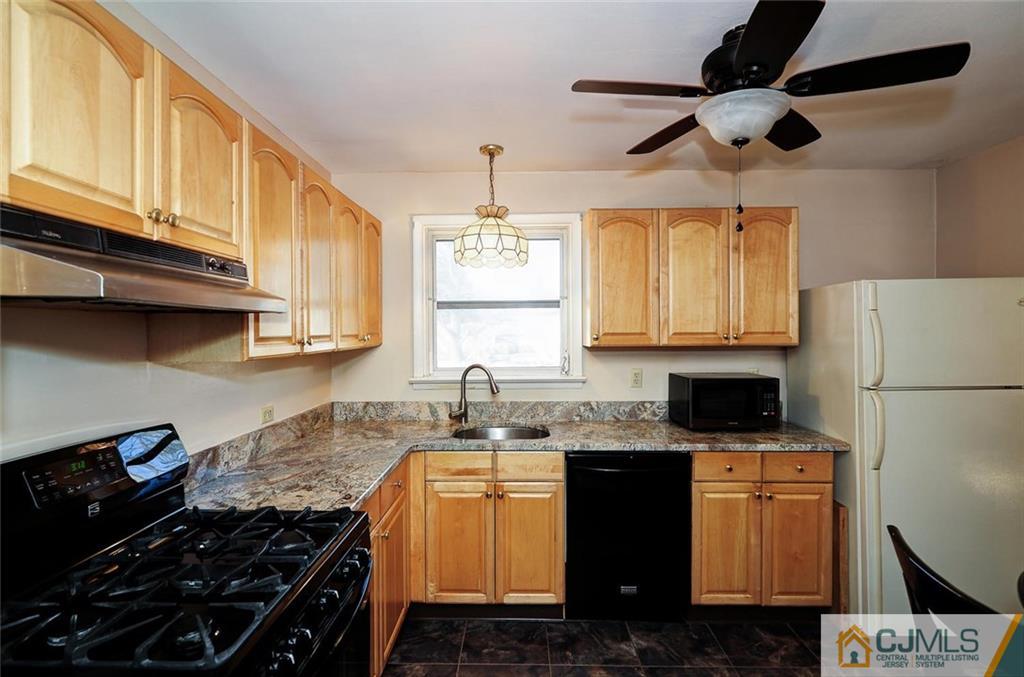 20 Barnett Road Lawrence Township, NJ 08648 - Photo 11 of 27 a kitchen with granite countertop a sink a stove and refrigerator