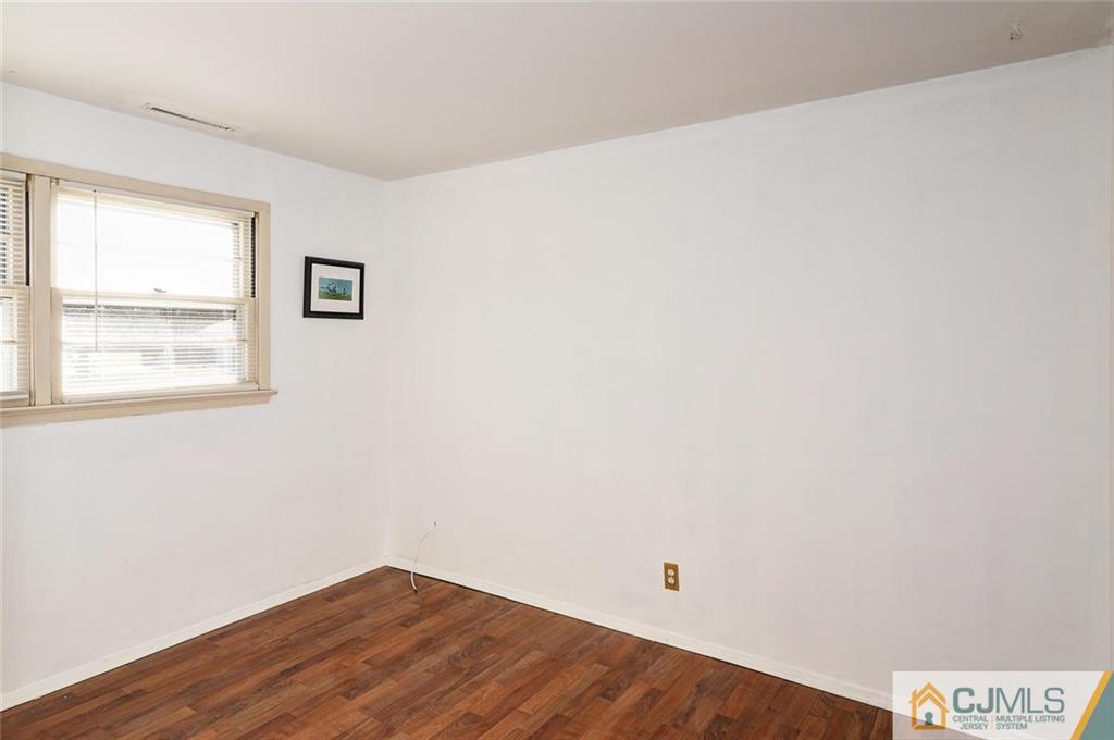 20 Barnett Road Lawrence Township, NJ 08648 - Photo 18 of 27 an empty room with wooden floor and windows