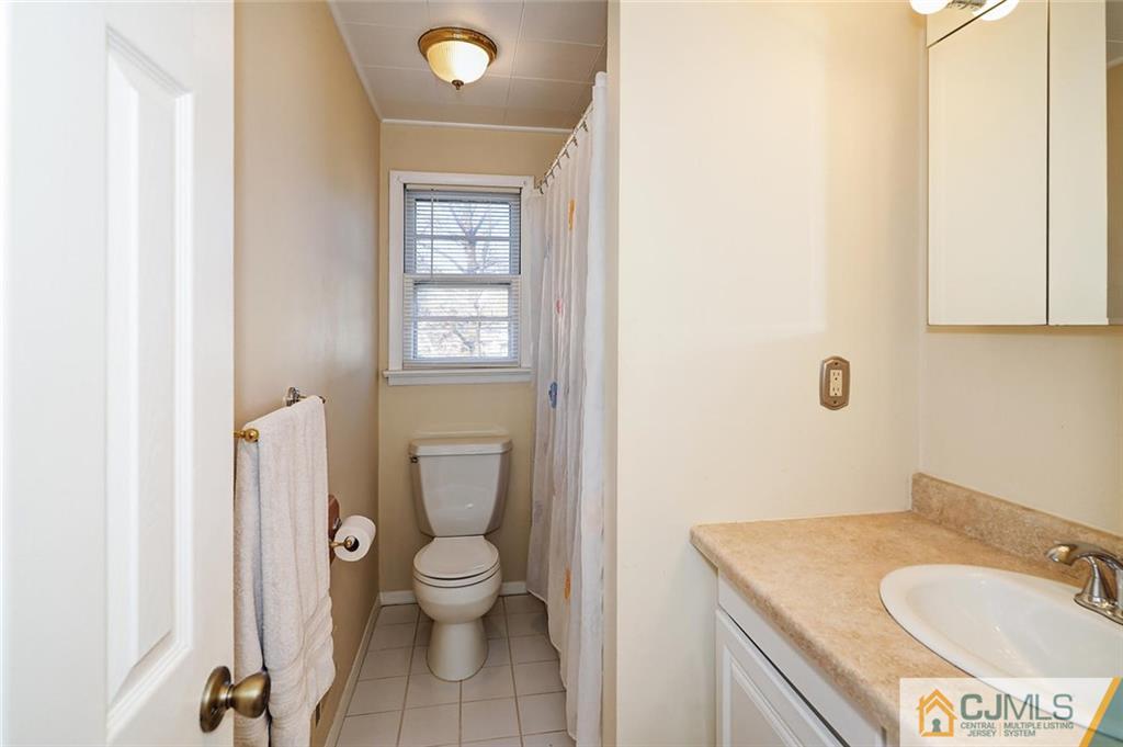 20 Barnett Road Lawrence Township, NJ 08648 - Photo 22 of 27 a bathroom with a granite countertop toilet sink and mirror