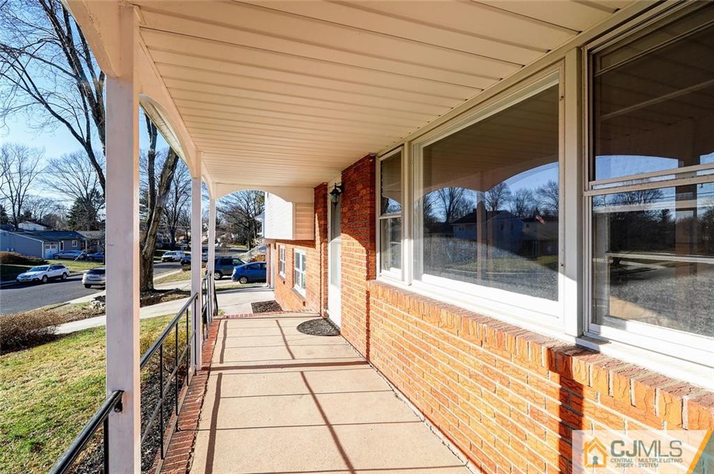 20 Barnett Road Lawrence Township, NJ 08648 - Photo 5 of 27 a view of a balcony with furniture and floor to ceiling window