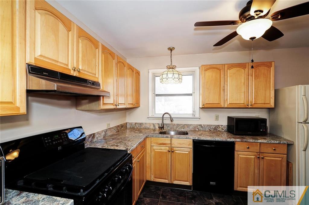 20 Barnett Road Lawrence Township, NJ 08648 - Photo 10 of 27 a kitchen with granite countertop stainless steel appliances a sink a stove and cabinets