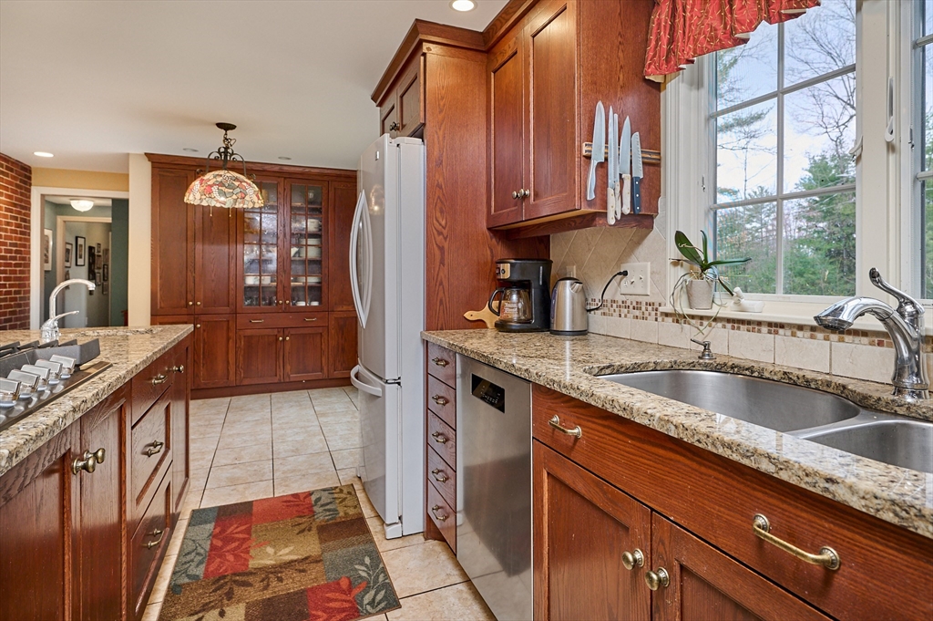 33 Echo Hill Road Amherst, MA 01002 - Photo 14 of 37 a kitchen with stainless steel appliances granite countertop a sink a stove and a wooden cabinets
