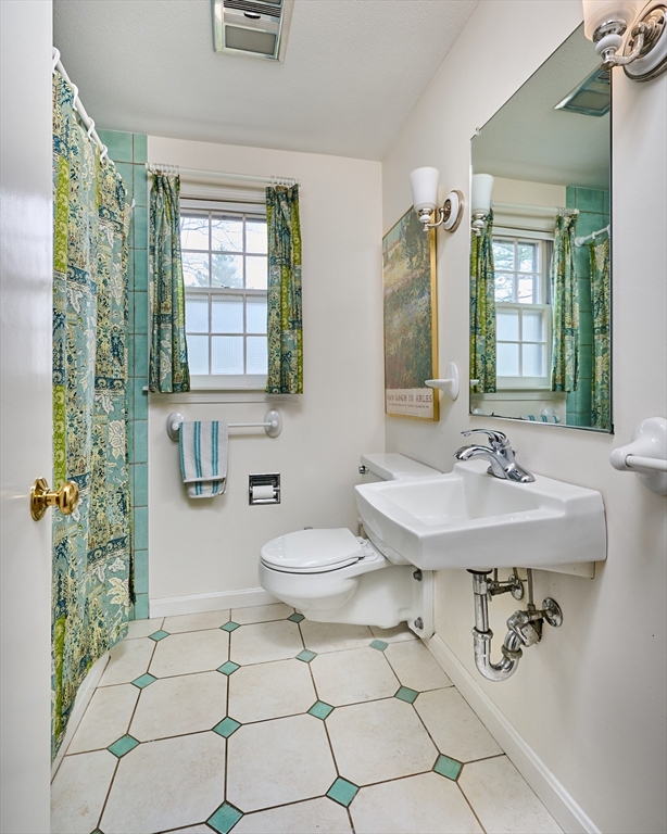 33 Echo Hill Road Amherst, MA 01002 - Photo 17 of 37 a bathroom with a sink a toilet and a mirror