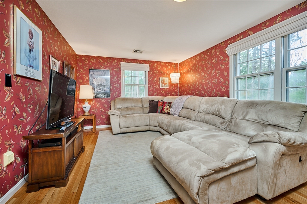 33 Echo Hill Road Amherst, MA 01002 - Photo 18 of 37 a living room with furniture a flat screen tv and a fireplace