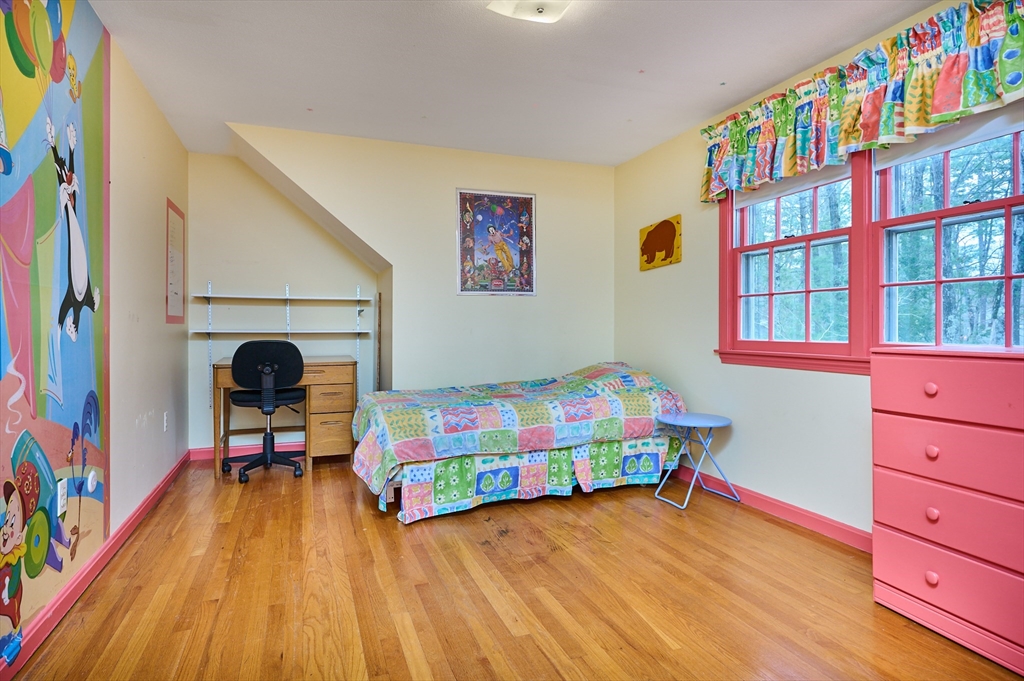 33 Echo Hill Road Amherst, MA 01002 - Photo 22 of 37 a bedroom with a bed and a wooden floor