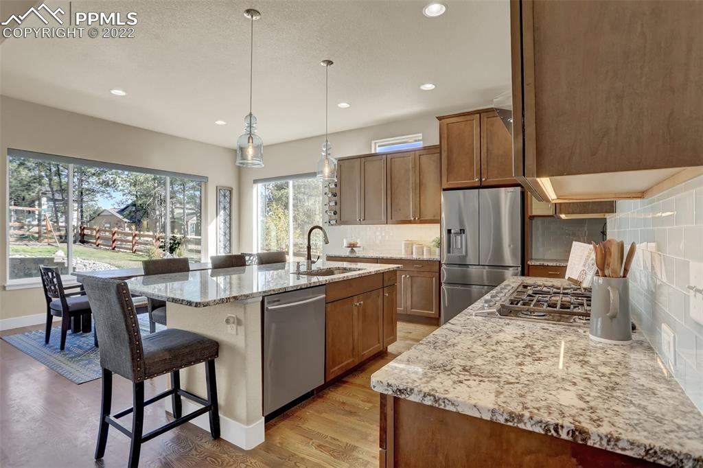 1435 Catnap Lane Monument, CO 80132 - Photo 12 of 47 a kitchen with a table and chairs in it