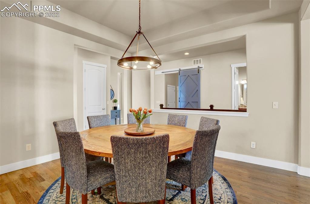 1435 Catnap Lane Monument, CO 80132 - Photo 13 of 47 a view of a dining room with furniture window and wooden floor